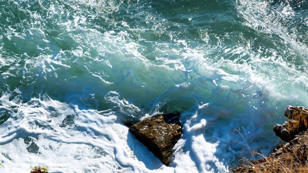 aegean sea rocky coast of greece waves and lot of foam