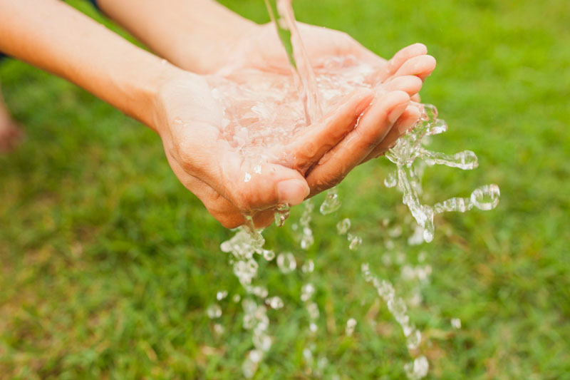 close up of hands under stream of water