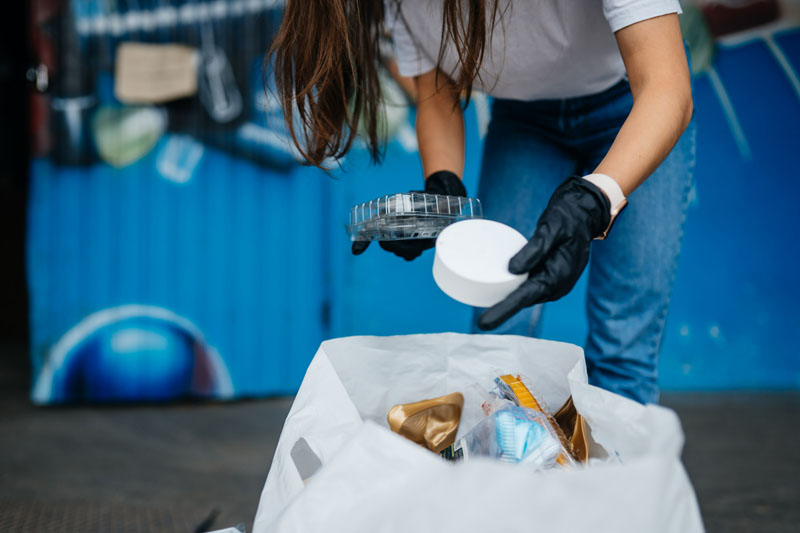 young woman sorting garbage concept of recycling zero waste